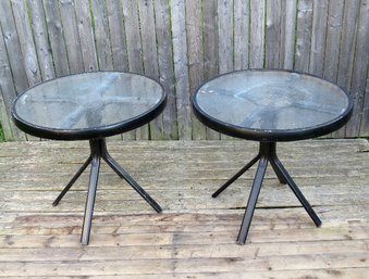 A Pair Of Round  Metal Outdoor Tables With Tempered Glass Tops