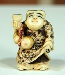 Vintage Japanese Carved Netsuke Of A Man Holding A Cup