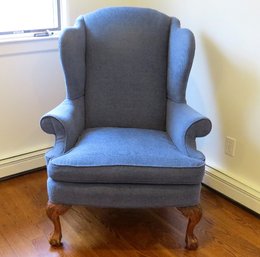 A Blue Wing Back Chair With Carved Legs