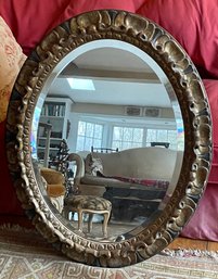 A Large Vintage Oval Mirror In A Hand Carved Wooden Frame