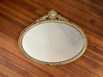 A Gorgeous Antique Oval Mirror With An Ornate Gilt Frame