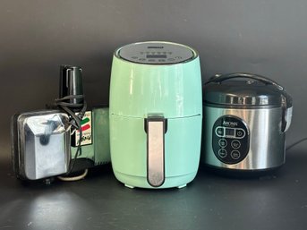 A Grouping Of Countertop Applicances: Air Fryer, Rice Cooker & Pizzelle Maker