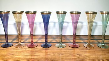 A Set Of 8 Fine Gold Rimmed Colored Glass Champagne Flutes