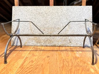 A Granite And Wrought Iron Dining Table