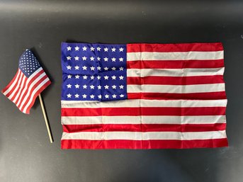 A Silk American Flag & A Small American Flag On A Stick