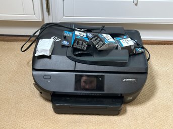 An HP Officejet 5740 Printer With Extra Ink Cartridges