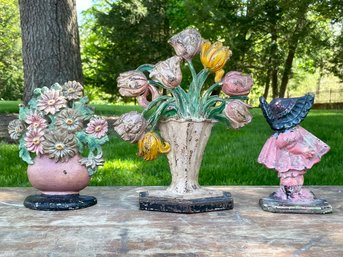 A Trio Of Antique Cast Iron Doorstops - Floral Bouquets And Bonneted Girl