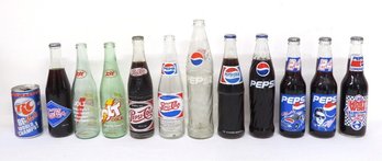 A Group Of Vintage Pepsi & Other Soda Bottles & Cans, Some Still Full Including Vintage & Nascar Pepsi's