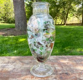 A Very Large Collection Of Sea Glass In Tall Glass Vessel