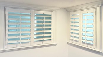 A Casement Window And Double Pane Glass Window With Interior Shutters