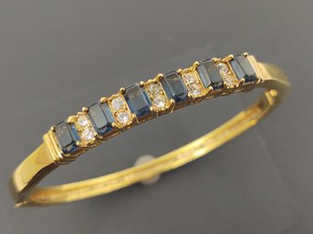 VINTAGE GOLD TONE BLUE & CLEAR RHINESTONE HINGED BANGLE BRACELET