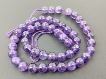 STRAND OF LOOSE ROUND NATURAL AMETHYST BEADS