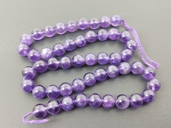 STRAND OF LOOSE ROUND NATURAL AMETHYST BEADS