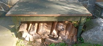 Rugged Vintage Wooden Table Used Outdoors With A Pile Of Split Firewood Too!