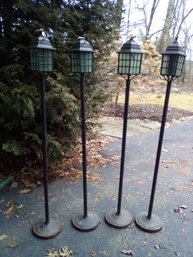 Four Tall Carriage Type Torch Lamps With Glass Panels