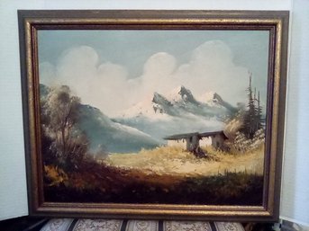 Oil On Board Signed By Artist Depicting Mountain Region With Buildings In Foreground Displayed In Wood Frame