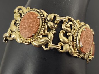 ANTIQUE ARTS & CRAFTS ERA REPOUSSE GOLD TONE BRACELET WITH GOLDSTONE