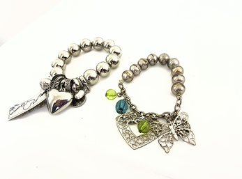 Two Silver Toned Charm Bracelets One With Tag