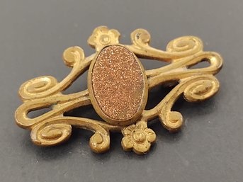 ANTIQUE BRASS TONED GOLDSTONE PIN