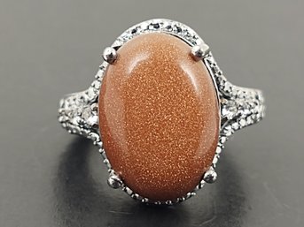 STUNNING SILVER PLATED GOLDSTONE CABOCHON & CZ RING