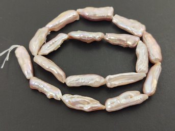 LOOSE STRAND OF LONG BAROQUE PINK PEARLS