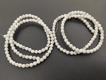 2 LOOSE STRANDS OF FACETED WHITE HOWLITE BEADS