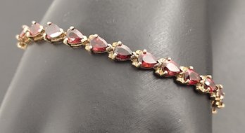 BEAUTIFUL GOLD OVER STERLING SILVER GARNET TENNIS BRACELET