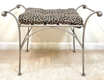 A Wrought Iron Vanity Seat With Animal Print Cushion