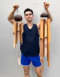 A Pair Of Massive Reed And Carved Wood Wind Chimes