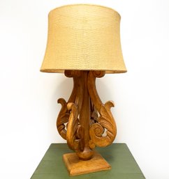 A Carved Wood Lamp With Linen Shade By Pottery Barn