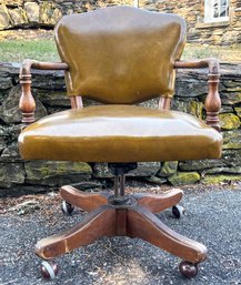 A Vintage Mid Century Carved Oak And Pleather Office Chair