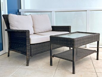 A Modern Loveseat And Cocktail Table In Resin Wicker By Harmonia Living.