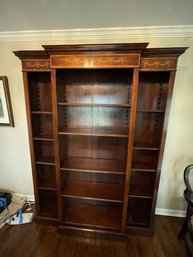 Towering Brown Wooden Bookcase With Accents