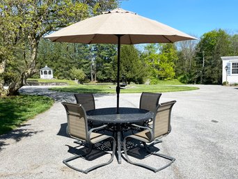 A Cast And Tubular Aluminum Patio Set With Umbrella