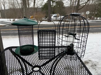 Two Bird Feeders And A Suet Cage