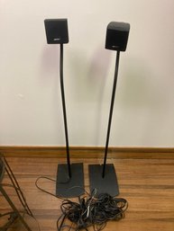 Two Bose Speakers With Stands