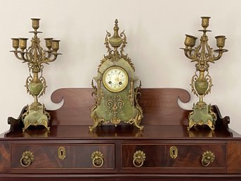 Gilt Metal Mounted Onyx Mantel Clock Garniture, The Clock With Porcelain Face And Matching Candelabras