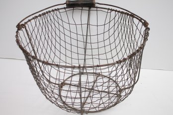 ANTIQUE INDUSTRIAL CHIC WIRE BASKET WITH A BLACK WOODEN HANDLE