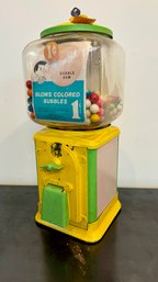 A Vintage Bubble Gum Machine With Key