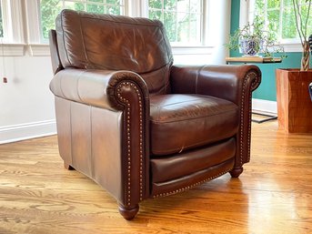 A Chestnut Leather Rolled Arm Chair With Nailhead Trim By Bassett Furniture