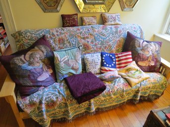 A Collection Of Colorful Throw Pillows Of Varying Sizes & Fabrics Plus A Large Throw