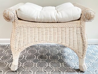 A Wicker Bench With Linen Cushion