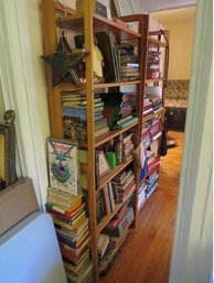 A Hallway Full Of Books On 4 Folding Bookshelves