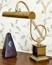 A Vintage Piano Lamp And Metronome