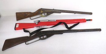 Two Vintage Daisy Lever Action BB Guns And A Red Toy Parade Rifle