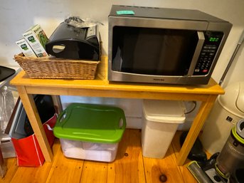 A WOOD TABLE, MICROWAVE, AND A FOOD SAVER