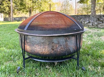 A Hammered Copper And Metal Mesh Fire Pit