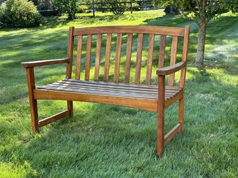 A Comfortable, Classic Outdoor Bench In Wood With A Naturally-Weathered Patina