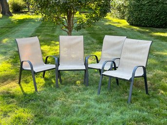 A Set Of Four Stackable Outdoor Chairs With Steel Frames & Sling Seats In Neutral Tones