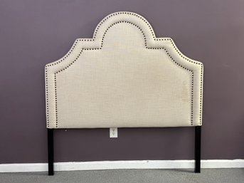 A Queen-Sized Upholstered Headboard With Nailhead Detailing
